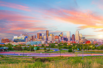 Buildings in city at sunset