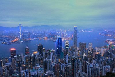 Illuminated cityscape against sky