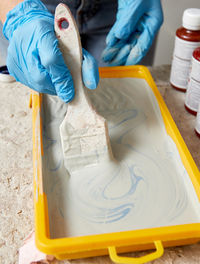 High angle view of man mixing paint