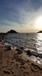 Scenic view of beach against sky during sunset