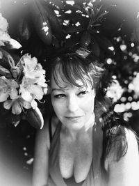 Portrait of smiling woman with flowering plants