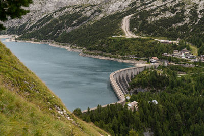 High angle view of road and a dam with artificial lake by mountain