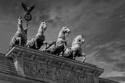 Low angle view of angel statue against sky