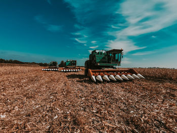 Tractor on agricultural field against sky