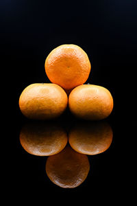 Close-up of oranges against black background