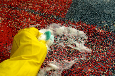 Cropped hand of person cleaning floor