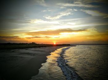 Scenic view of beach against sky during sunset