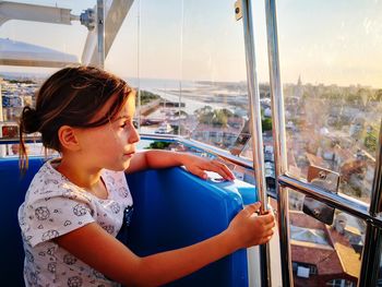 Girl looking through window