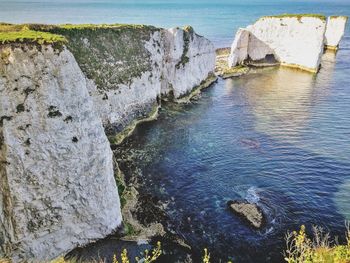 High angle view of rocks on sea shore