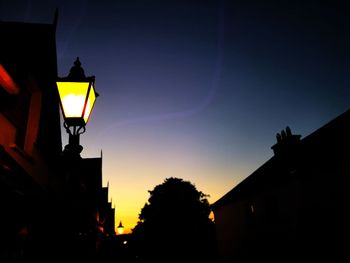 Low angle view of silhouette buildings against sky at dusk