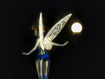 Close-up of illuminated lighting equipment against black background