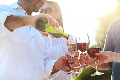 Group of people drinking wine outdoors