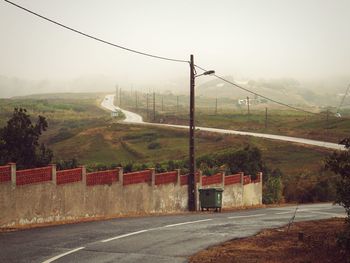 Road by mountain against clear sky