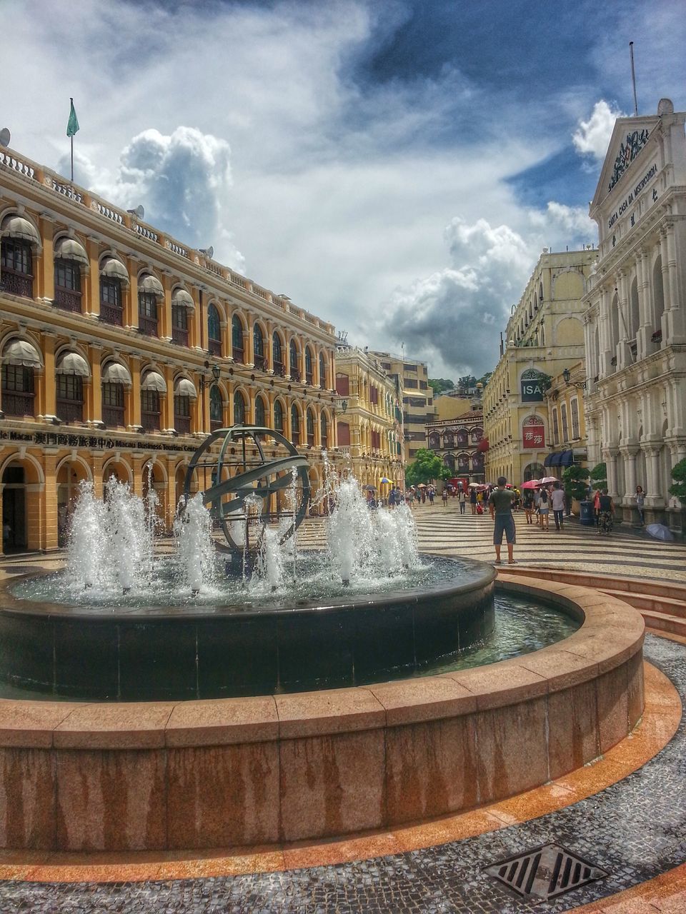 architecture, building exterior, built structure, fountain, water, sky, travel destinations, famous place, city, tourism, travel, international landmark, cloud - sky, history, large group of people, motion, men, incidental people, capital cities