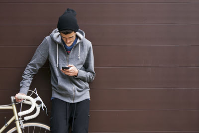 Man with mobile phone and bicycle
