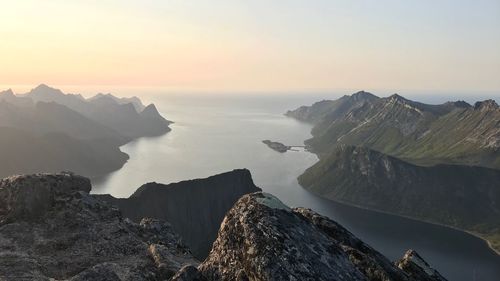 Panoramic view of sea and mountains against sky during sunset