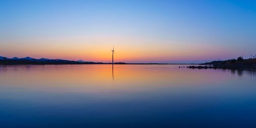 Scenic view of sea against clear sky during sunset