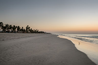 Scenic view of beach against sky during sunset