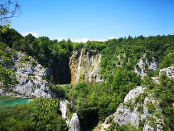 Scenic view of waterfall against sky