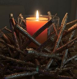 Close-up of illuminated candles on table