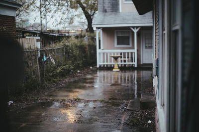 Buildings seen through wet window of house