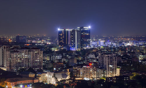 High angle view of illuminated city buildings at night