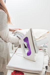 Woman hands ironing on the desk at home