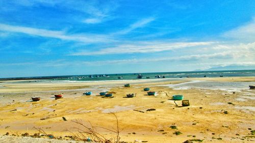 Scenic view of beach against blue sky