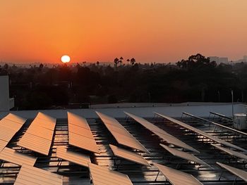High angle view of buildings against orange sky