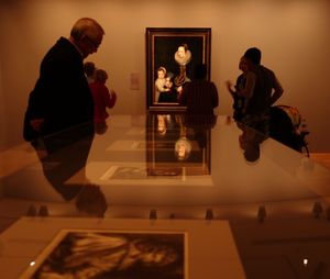 Rear view of people sitting in museum