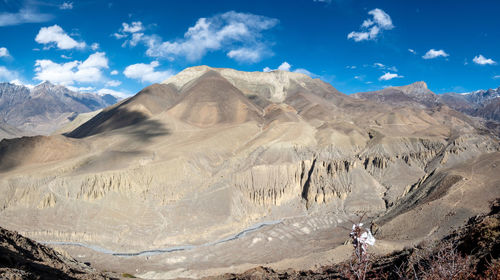 Scenic view of mountain range against cloudy sky