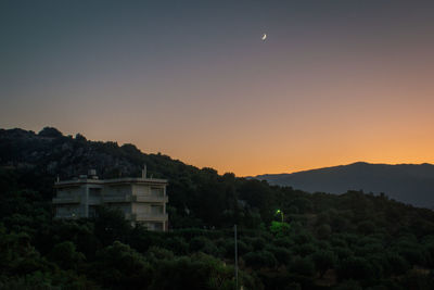 Scenic view of mountains against clear sky at sunset