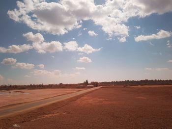 Scenic view of land road against sky