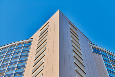 Low angle view of modern building against clear blue sky