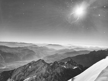 Scenic view of snowcapped mountains against sky at night