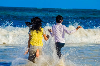 Children playing in water at beach