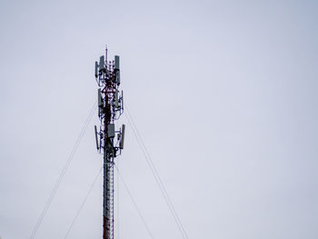 Low angle view of communications tower against clear sky