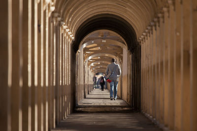 People walking in corridor of building