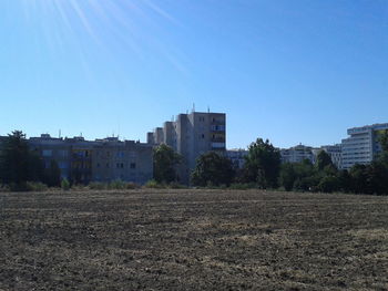 Buildings against clear blue sky