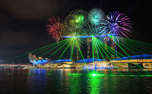 Firework display over river at night