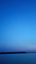 Scenic view of calm sea against clear sky