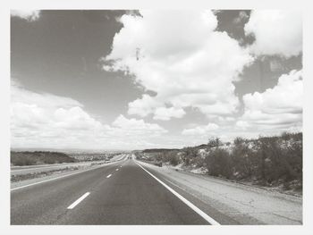 Road passing through landscape against sky