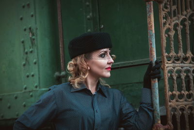 Beautiful woman wearing hat while standing by old train