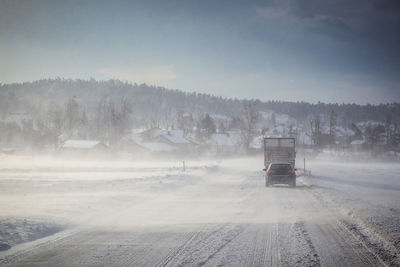 Car on road against sky during winter