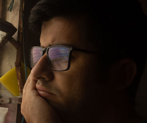 Close-up portrait of man wearing eyeglasses