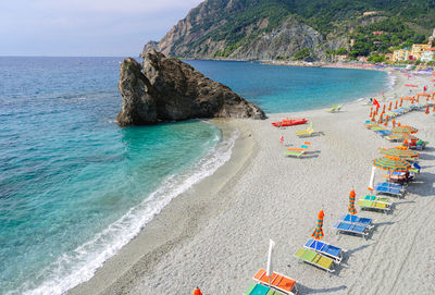 High angle view of parasols and lounge chairs at sea shore