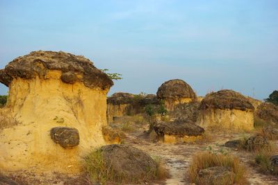 Mushroom-shaped rock formations against sky