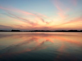 Scenic view of lake against romantic sky at sunset