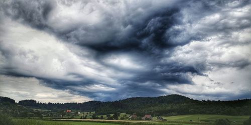 Scenic view of landscape against cloudy sky