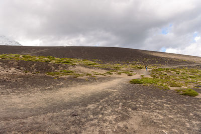 Road amidst land against sky